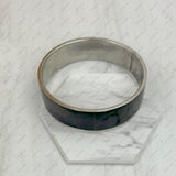 BR231209-01                                  silver metal with black shell bangle