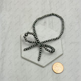 BR250524-01           Silver Navajo pearl with bow tie beads stretch bracelet