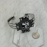 Silver bracelet with decorative clasp on a marble surface