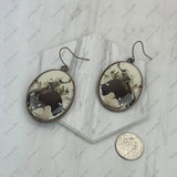 ERZ240519-10                      Silver metal with western cowboy oval Earrings