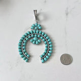 PDS250901-01-BLUE           Silver metal with blue turquoise stone squash blossom pendent