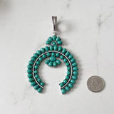 PDS250901-01-BLUE           Silver metal with blue turquoise stone squash blossom pendent